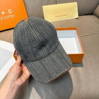 Louis Vuitton denim cap shown from side, dark blue-gray with LV stitching details