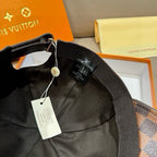Louis Vuitton cap with adjustable strap and hanging tag, black fabric lining interior
