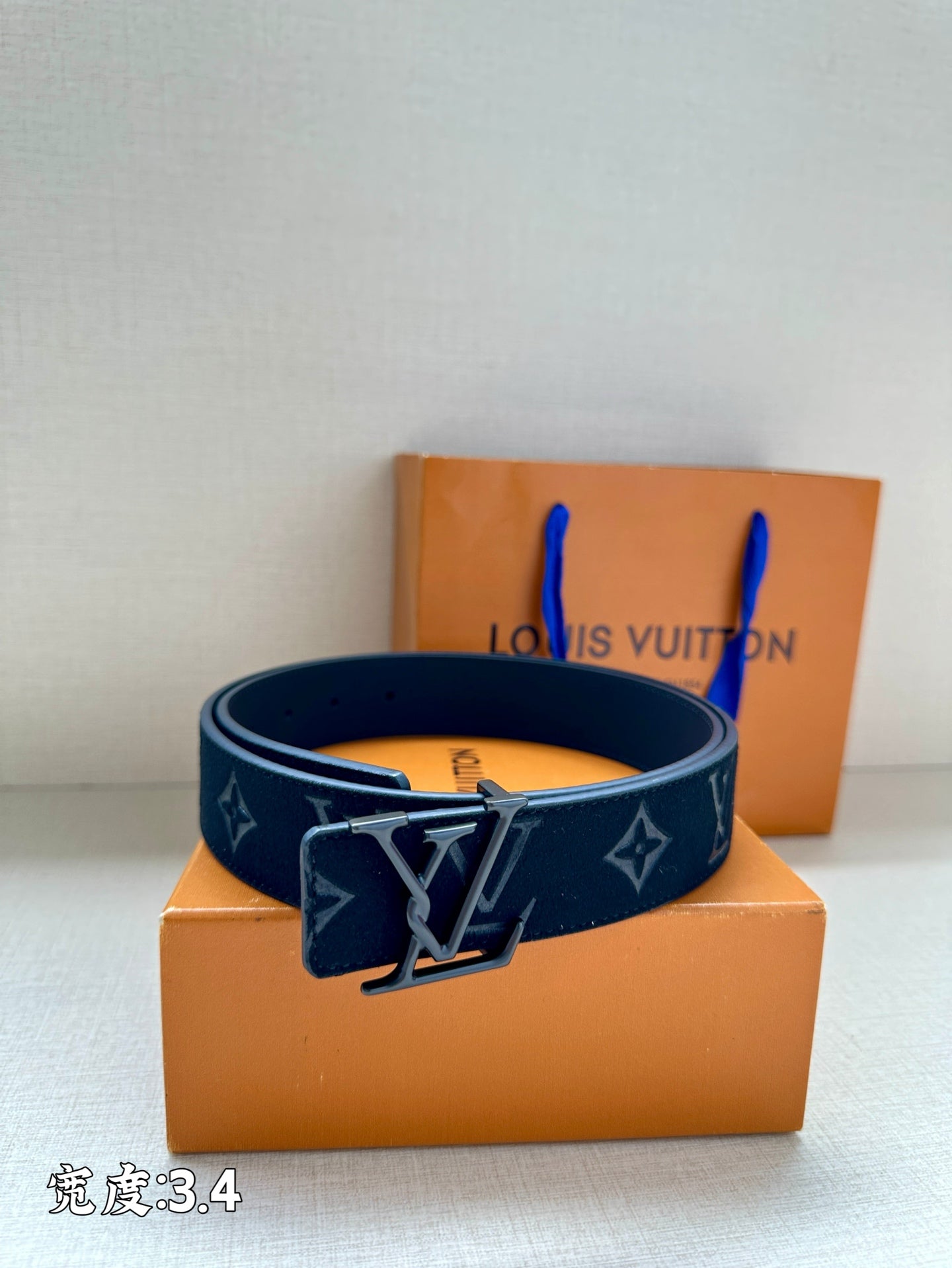 Dark blue designer belt with monogram print and silver-tone buckle