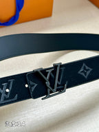 Dark blue Louis Vuitton belt with embossed monogram and metal buckle