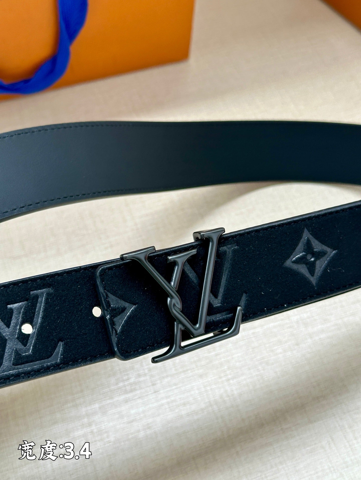 Dark blue Louis Vuitton belt with embossed monogram and metal buckle