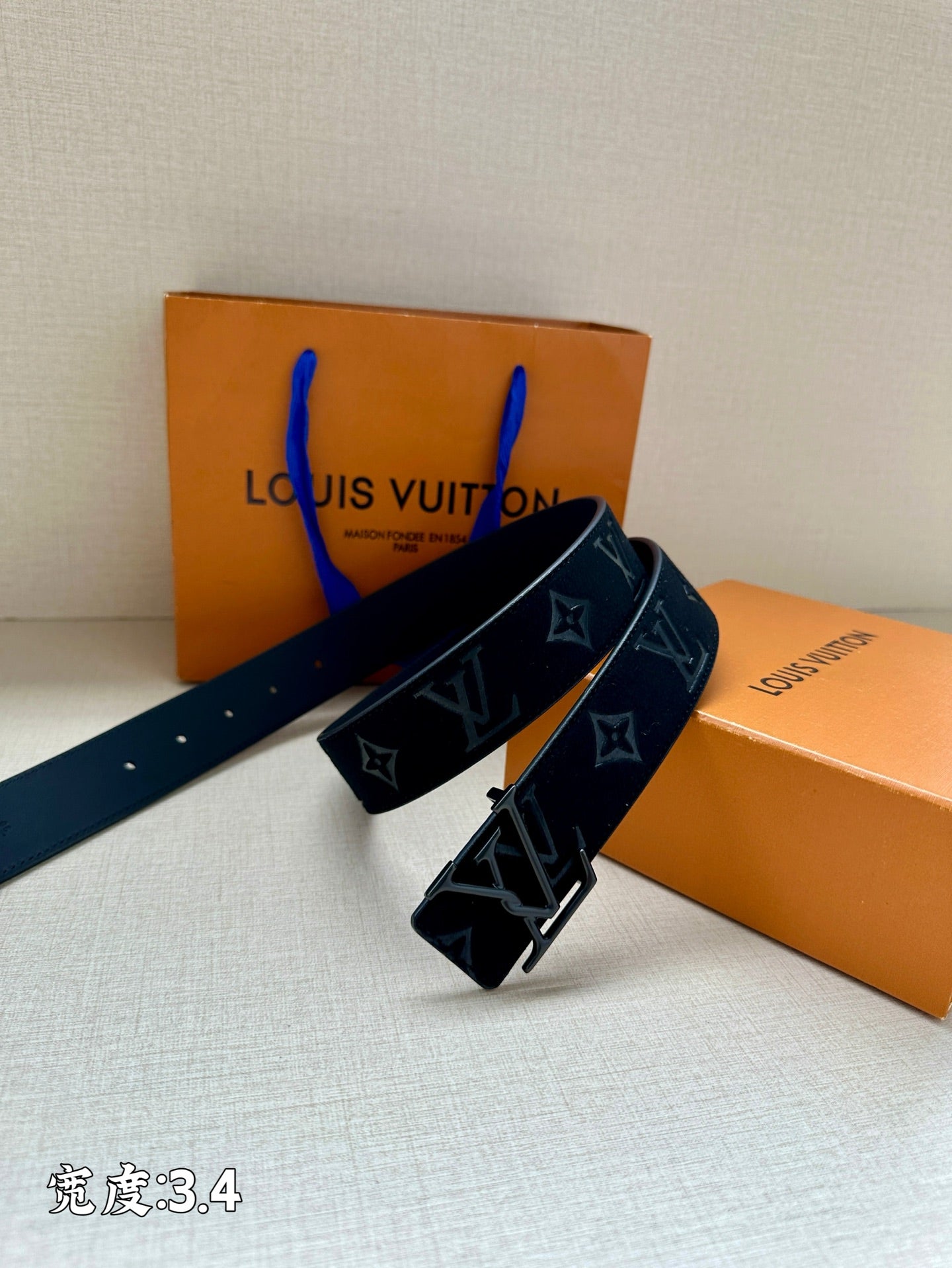 Dark blue belt with monogram print and silver-tone clasp buckle