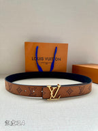 Monogram leather belt with gold-tone V buckle, tan/brown strap and dark backing