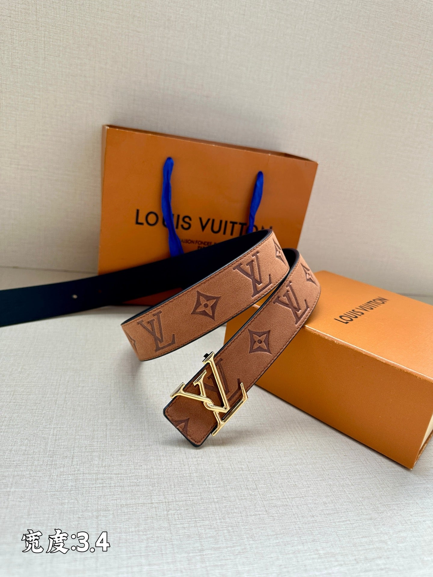 Monogram leather belt with gold-tone V buckle, tan/brown strap with repeating LV symbols