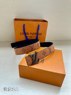 Louis Vuitton belt angled view: brown monogram strap with oversized dark buckle