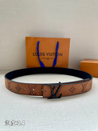 Louis Vuitton belt with brown monogram strap and dark metal buckle