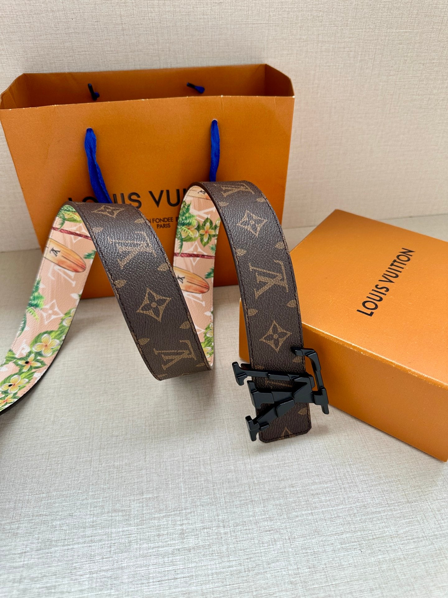Reversible monogram belt with colorful floral reverse and black buckle