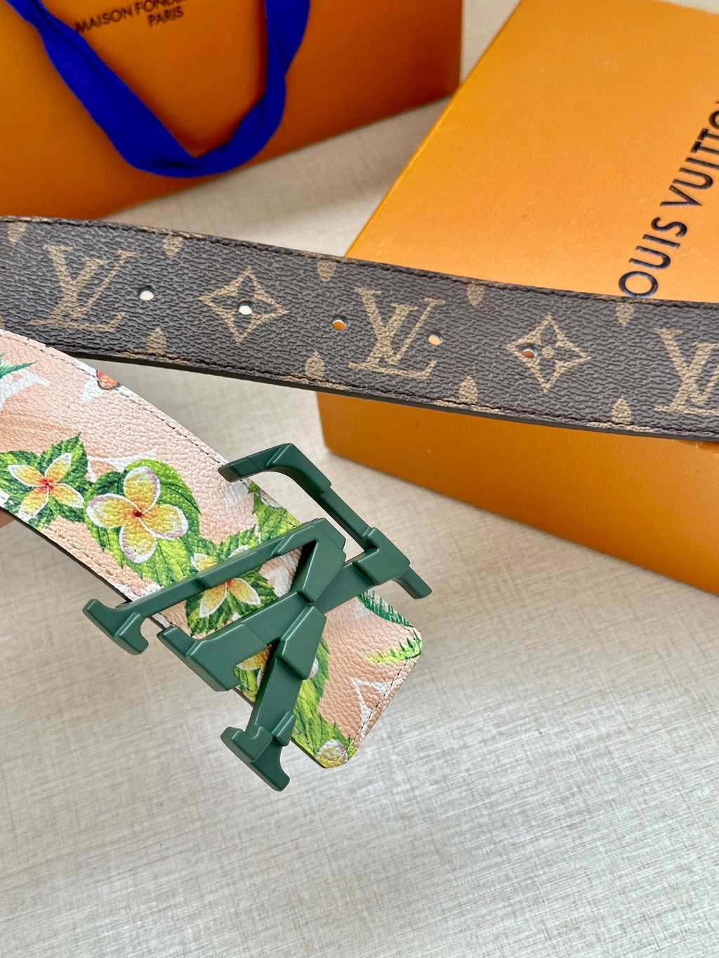 Louis Vuitton belt with dark monogram strap and floral panel, green buckle