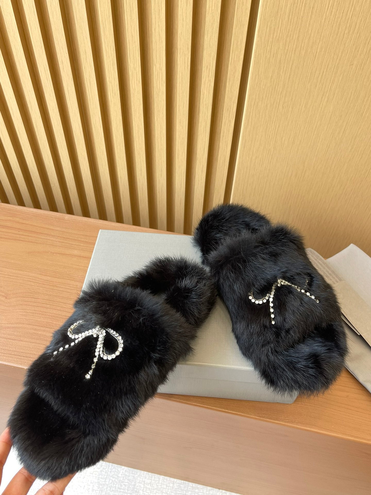 Balenciaga fuzzy slide sandals with crystal bow trim on dark fur
