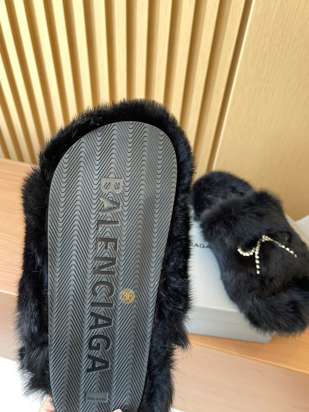 Balenciaga fuzzy sandal with textured outsole visible and dark fur upper