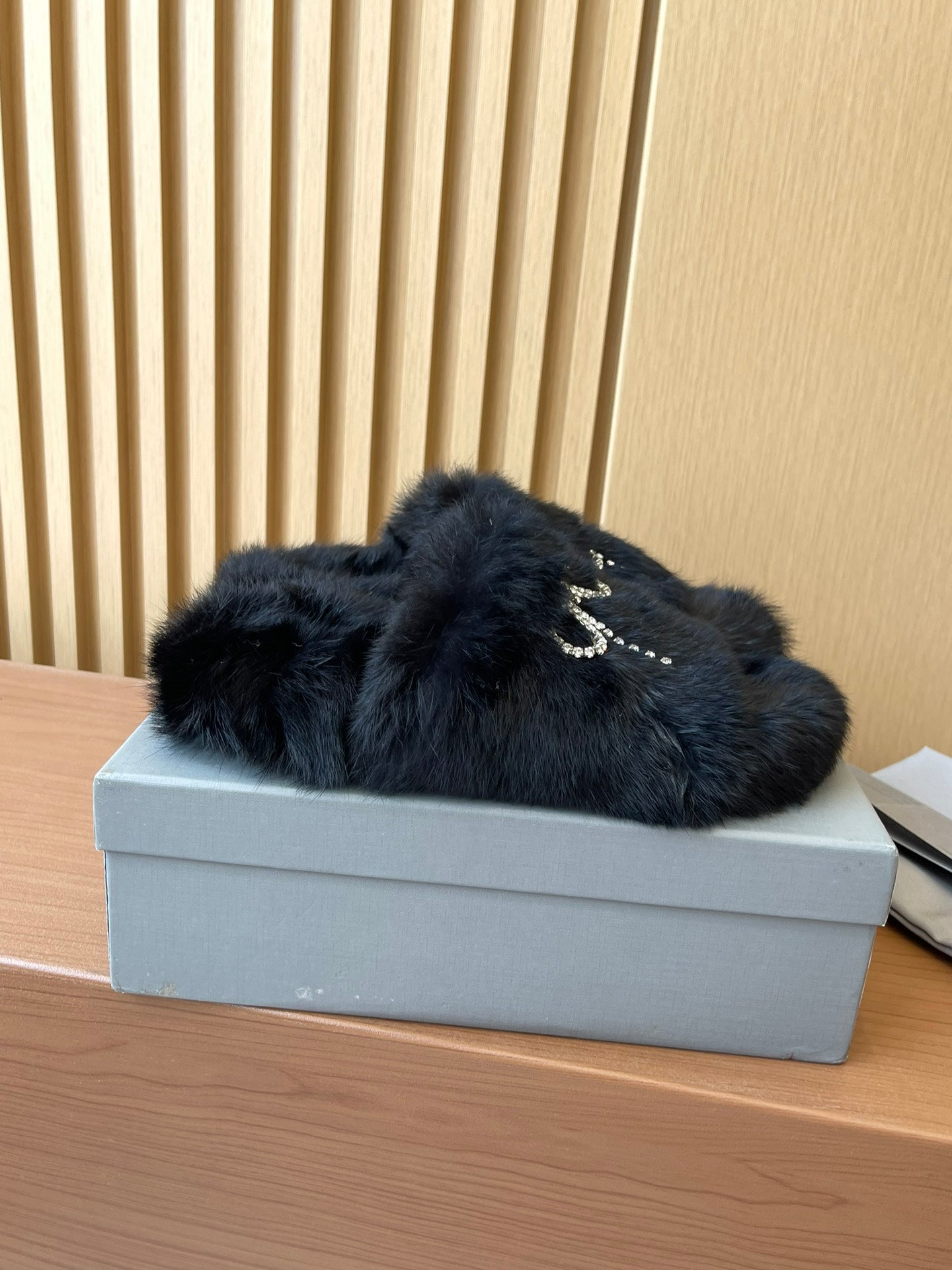 Balenciaga fuzzy slide sandals with jeweled bow detail on dark upper