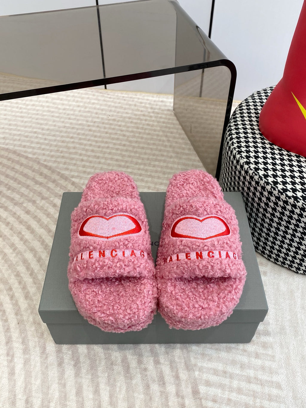Pink fuzzy slide sandals with red heart logo and open toe