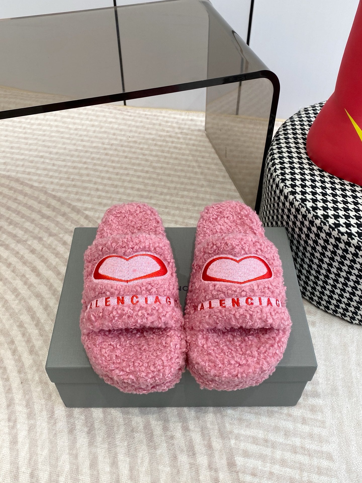 Pink fuzzy slide sandals with red heart logo and open toe