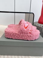 Pink fuzzy slide sandal, side view, red heart logo and BALENCIAGA text