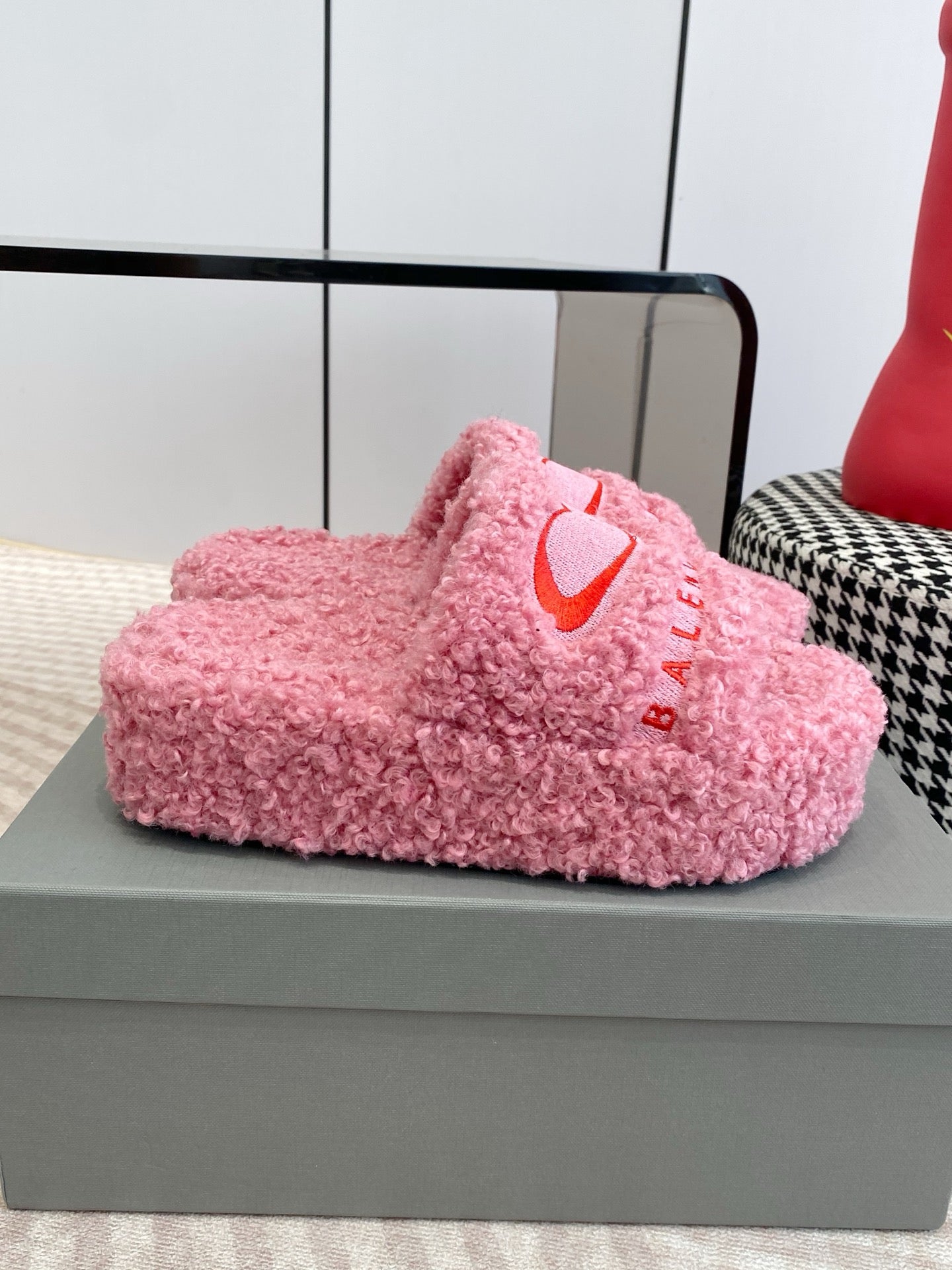 Pink fuzzy slide sandal, side view, red heart logo and BALENCIAGA text