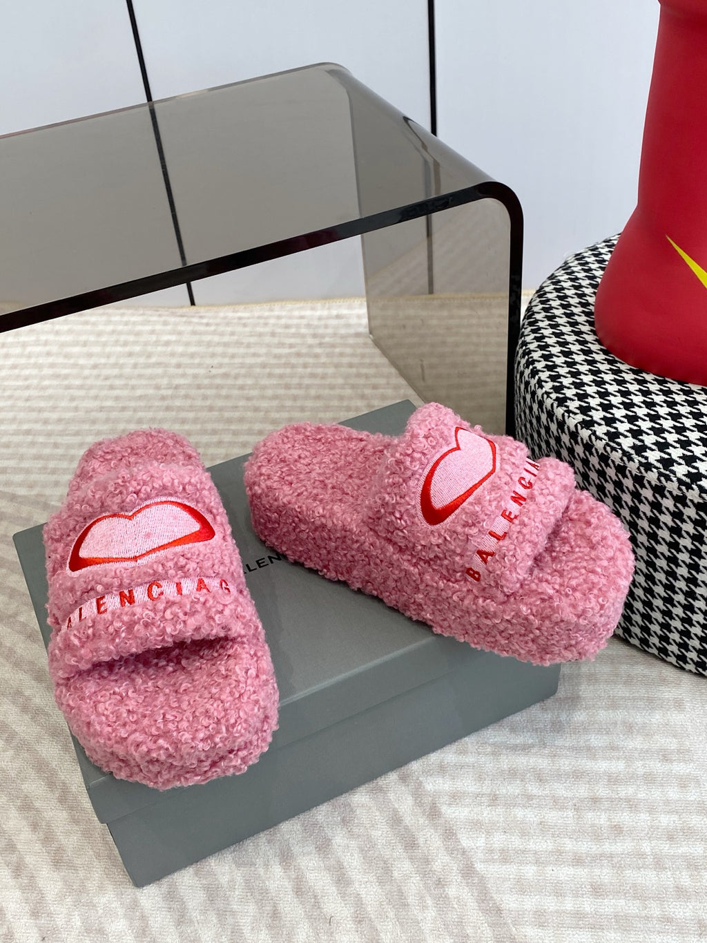 Pink fuzzy slide sandals with red heart logo, pair on box