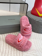 Pink fuzzy slide sandals with red heart logo and BALENCIAGA text on straps