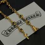 Gold charm bracelet with blue flower charms on a white product tag, close up.