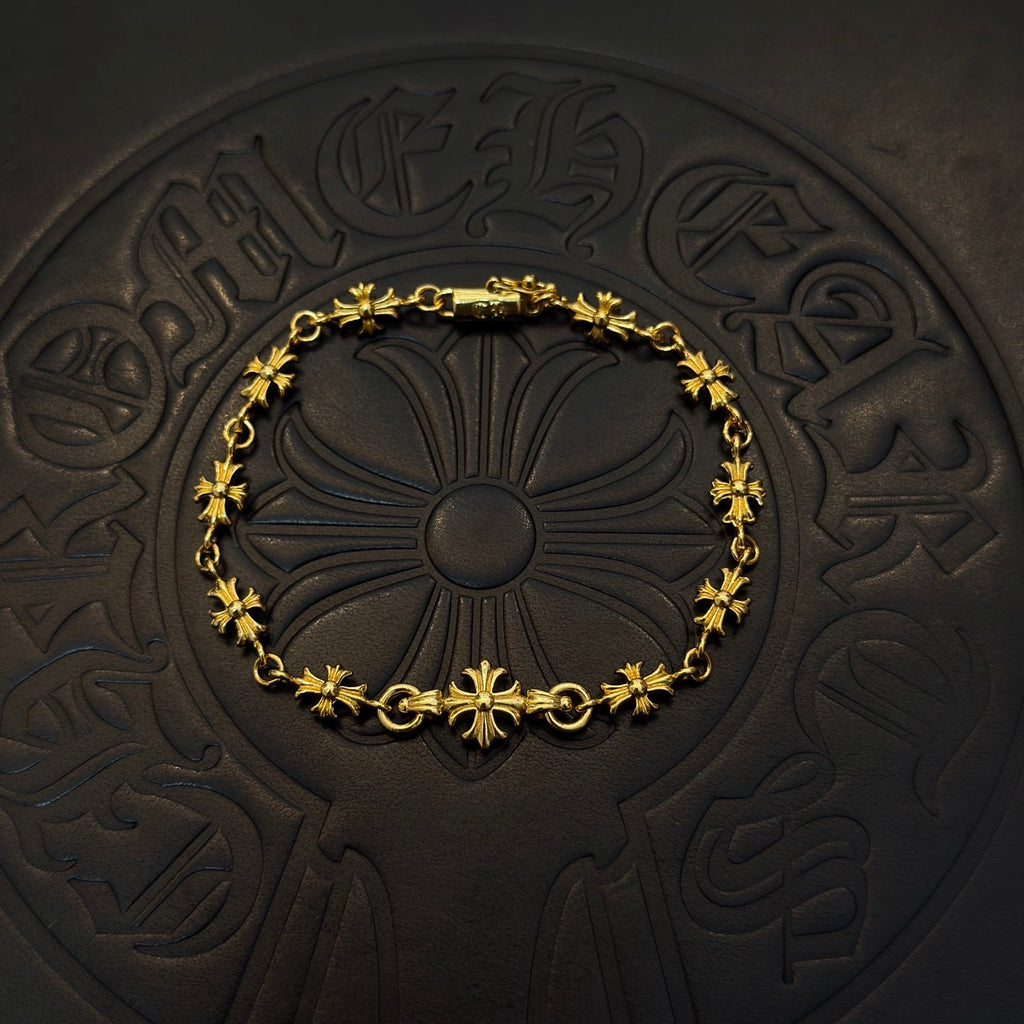 Gold-tone link bracelet with green flower charms and round floral center
