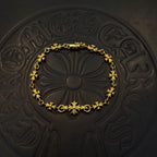 Gold-tone link bracelet with green flower charms and round floral center