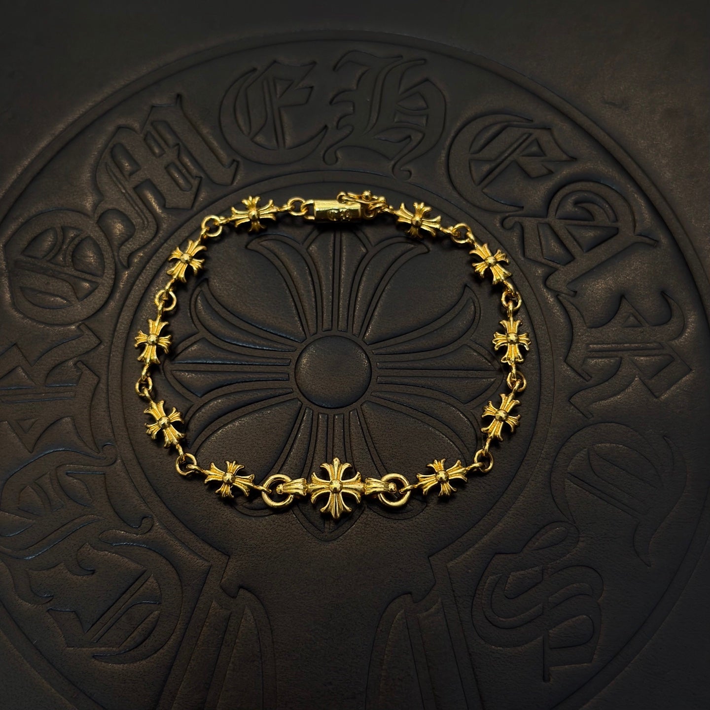 Gold-tone link bracelet with green flower charms and round floral center