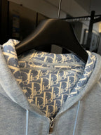 Light gray zip-up hoodie with patterned hood lining and metal front zipper
