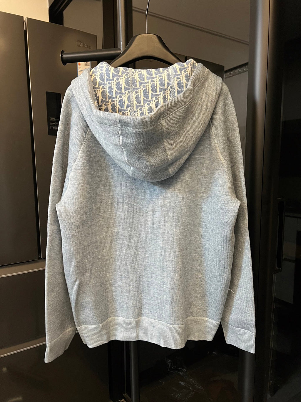 Light gray zip-up hoodie with hooded back and patterned interior lining