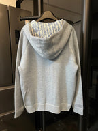 Light gray zip-up hoodie with hooded back and patterned interior lining