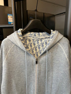 Light gray zip-up hoodie with hood and full front zipper, patterned inner lining