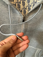 Light gray hoodie front zipper pull with corded hood drawstrings