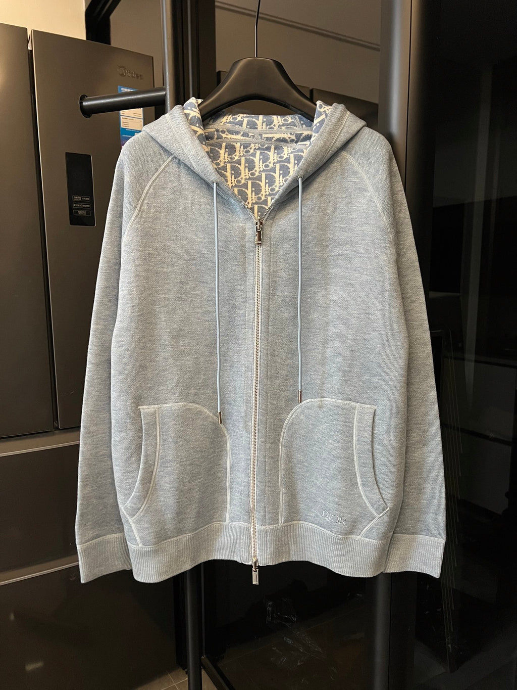 Light gray zip-up hoodie with hood and two front pockets
