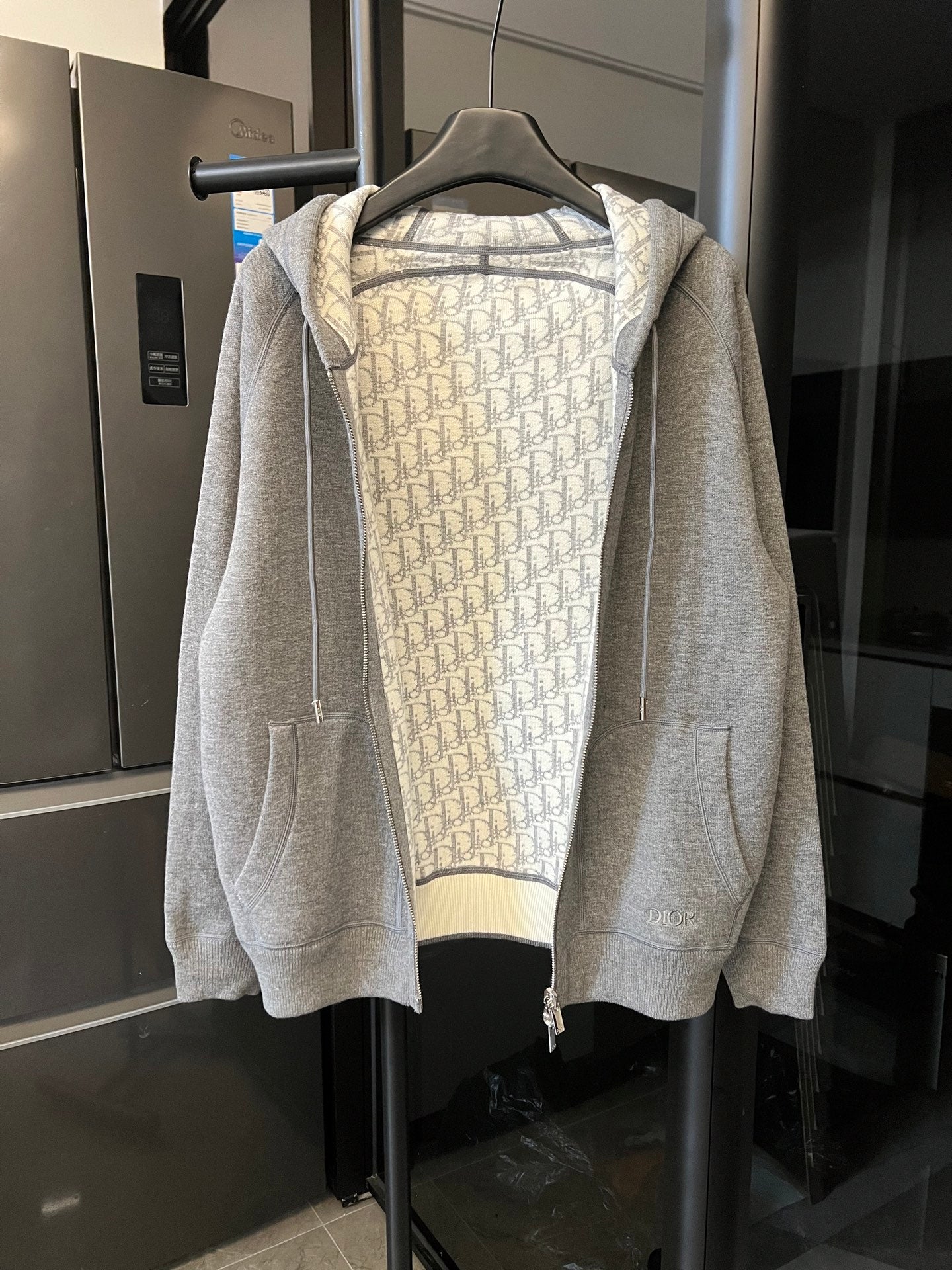 Gray heather zip-up hoodie with hood and monogram print lining, front zipper