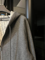 Gray heather zip-up hoodie with long sleeves and ribbed cuffs
