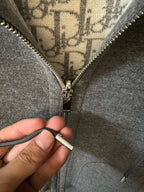 Gray heather zip-up hoodie with metal zipper pull and front zipper details