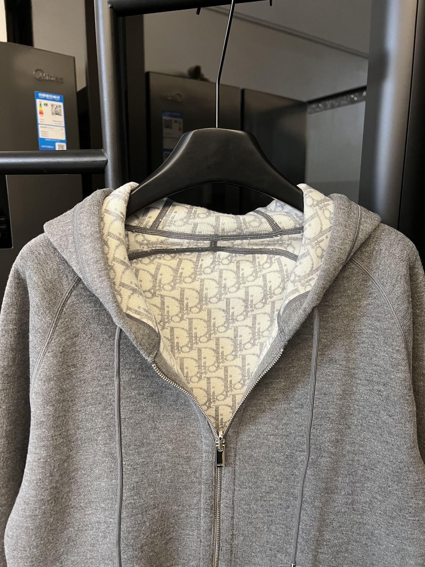 Gray heather zip-up hoodie with hood and front zipper, monogram-lined collar
