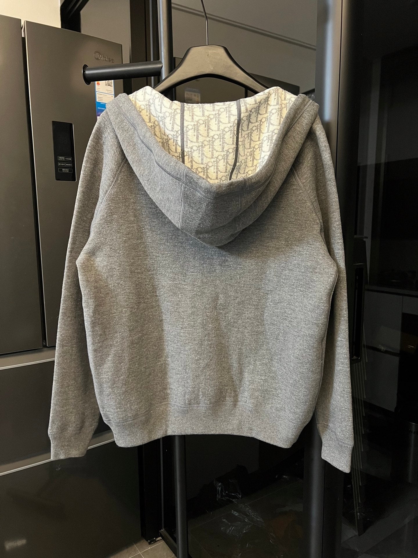 Gray heather zip-up hoodie with hood, monogram-lined interior, and front zipper