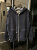 Navy zip-up hoodie with hood, front pockets, and beige Dior logo patterned lining.