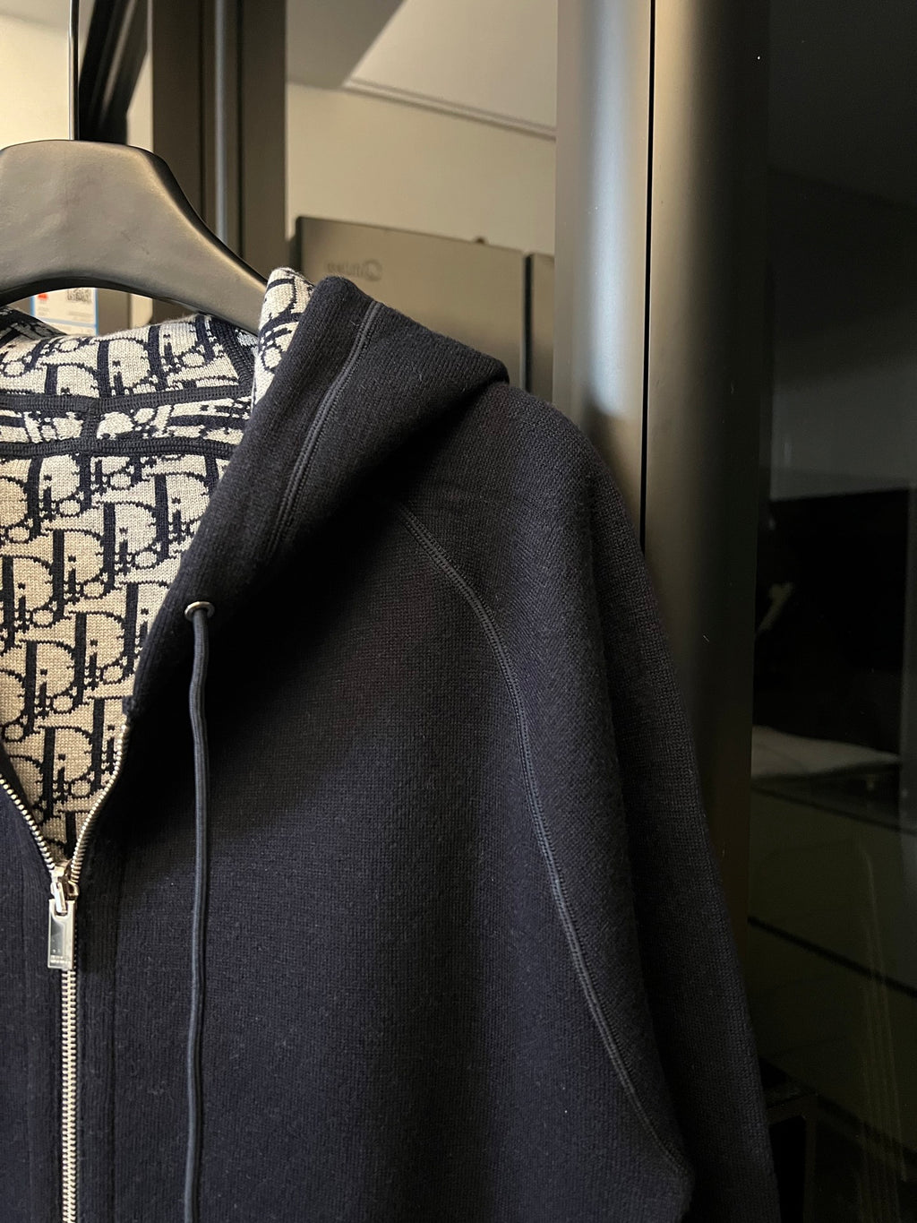 Navy zip-up hoodie with sleeve detail and Dior monogram hood lining.