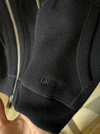 Dark hoodie hem with Dior logo on knit cuff and gold zipper trim.