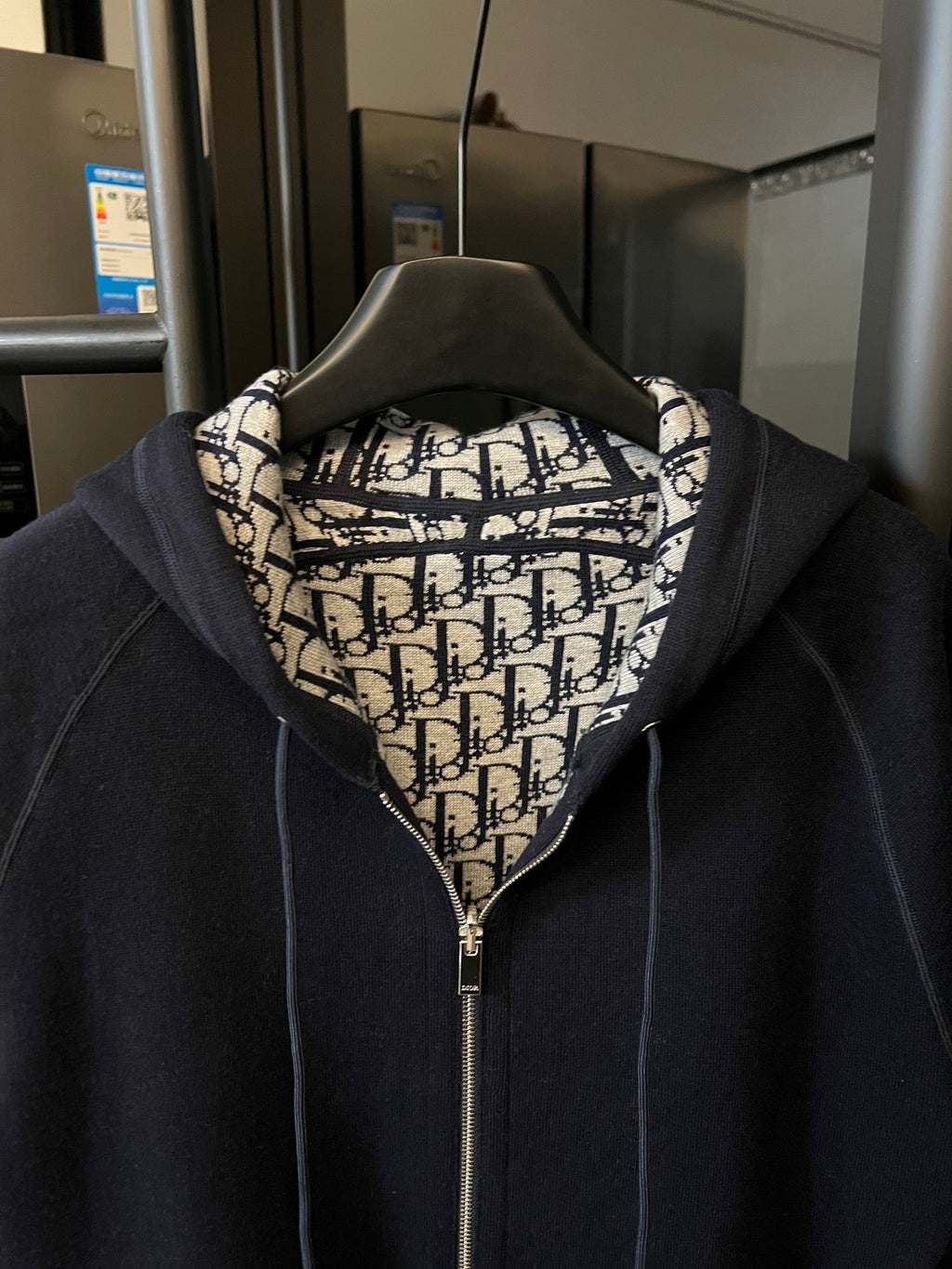 Navy zip-up hoodie with hood and Dior monogram-lined collar.