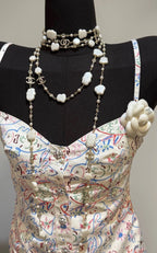 Pearl charm necklace with white shell clover charms and gold-tone chain on a mannequin