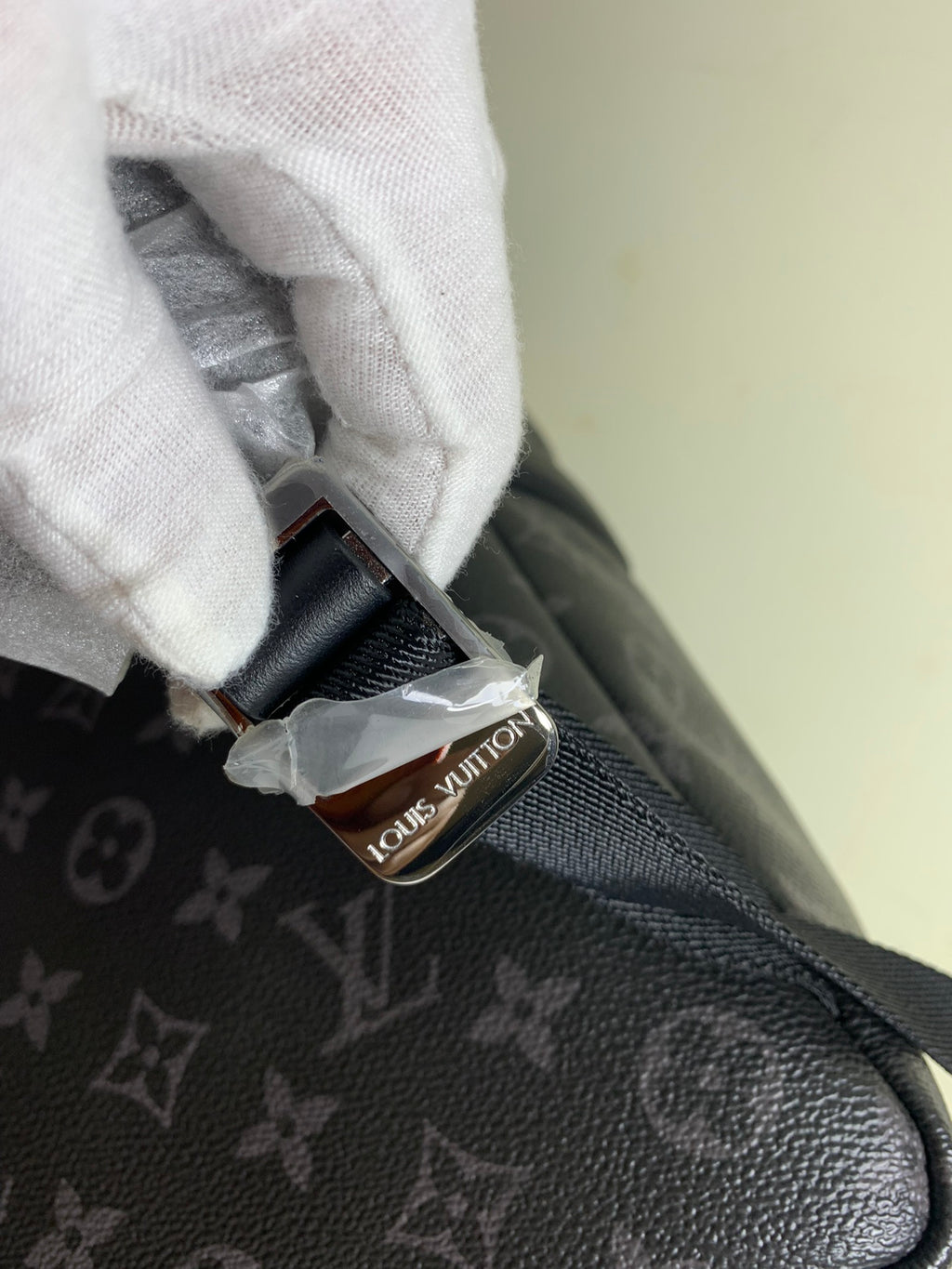 Louis Vuitton monogram bag interior strap and stitched leather tab, dark gray