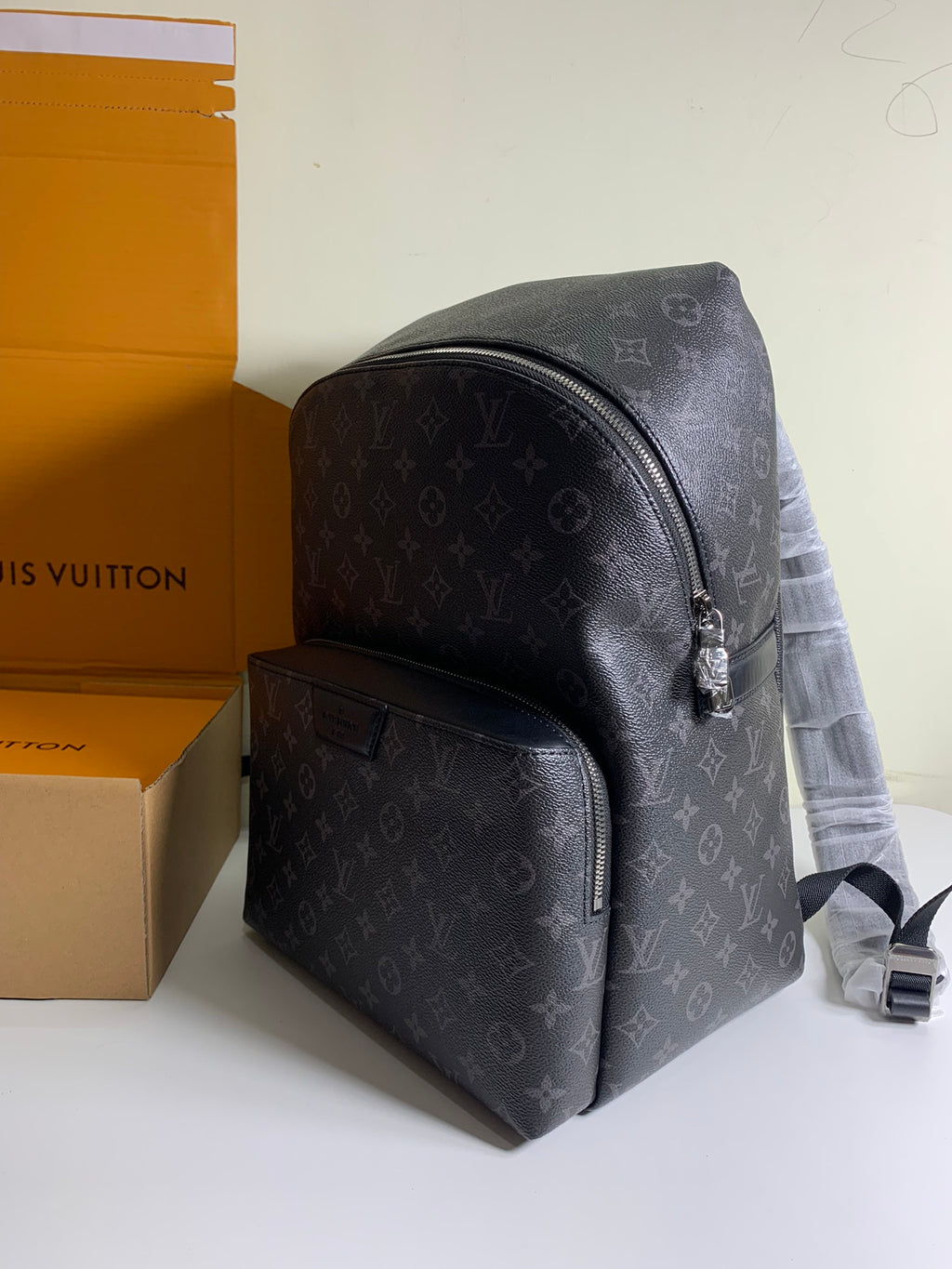 Louis Vuitton monogram backpack with front pocket and top zip, black leather trim