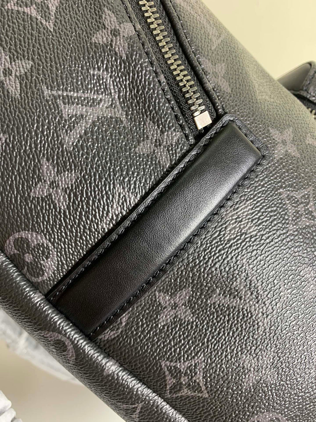Louis Vuitton monogram bag zipper pull with leather trim, dark gray