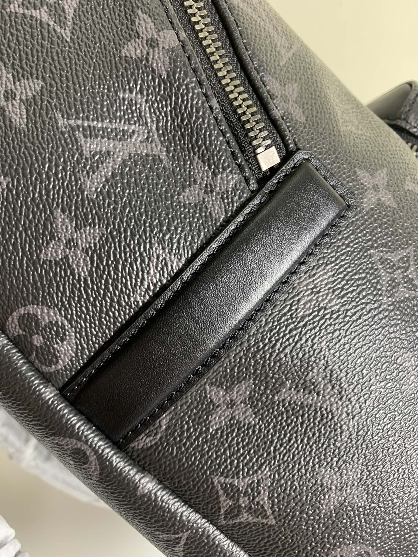 Louis Vuitton monogram bag zipper pull with leather trim, dark gray