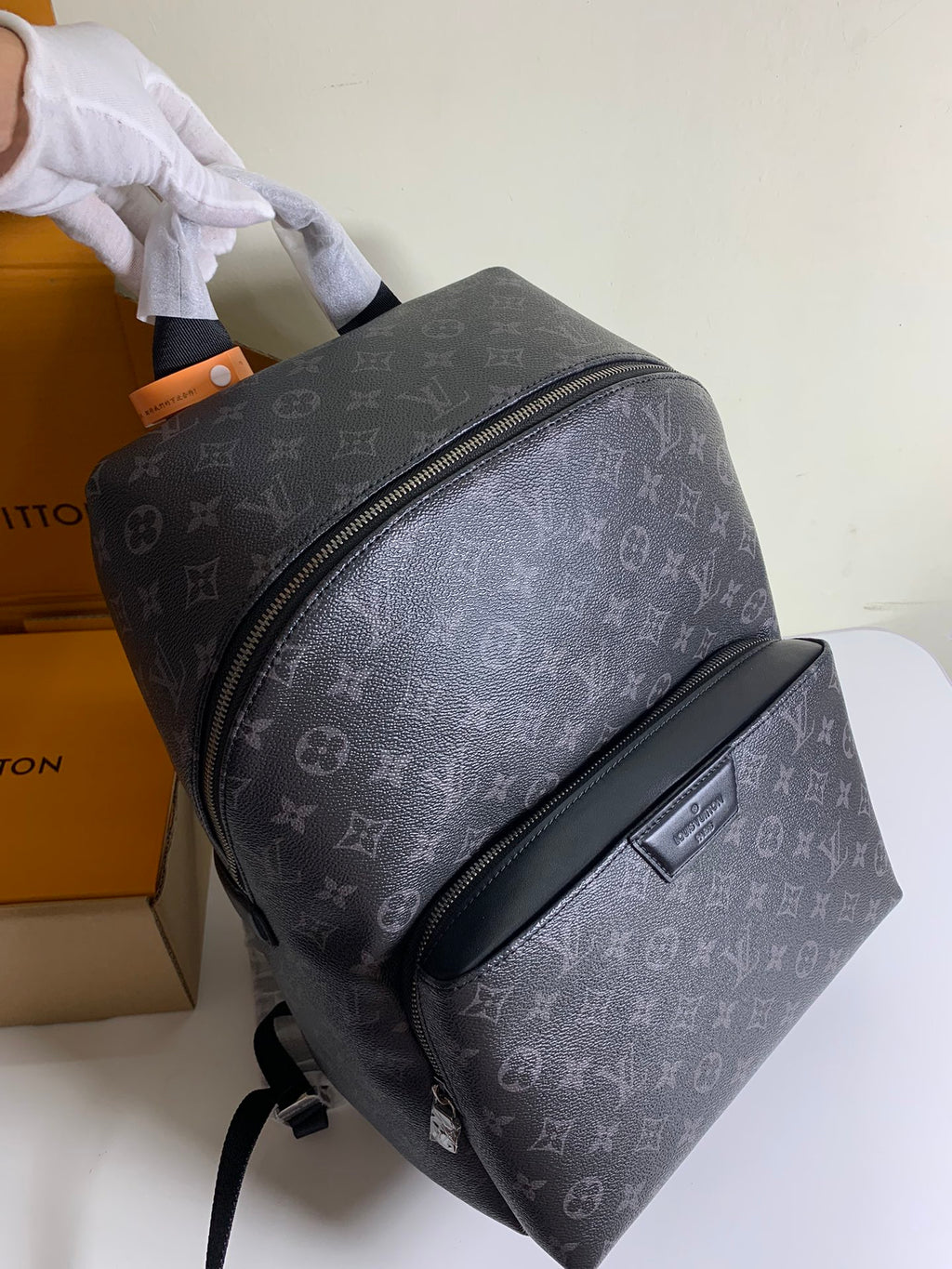 Louis Vuitton monogram backpack with curved side zipper, dark gray leather trim