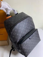 Louis Vuitton monogram backpack with curved side zipper, dark gray leather trim