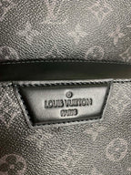 Louis Vuitton Paris leather label on dark monogram bag, textured surface
