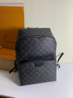 Louis Vuitton monogram backpack with front zipper pocket, dark gray leather trim