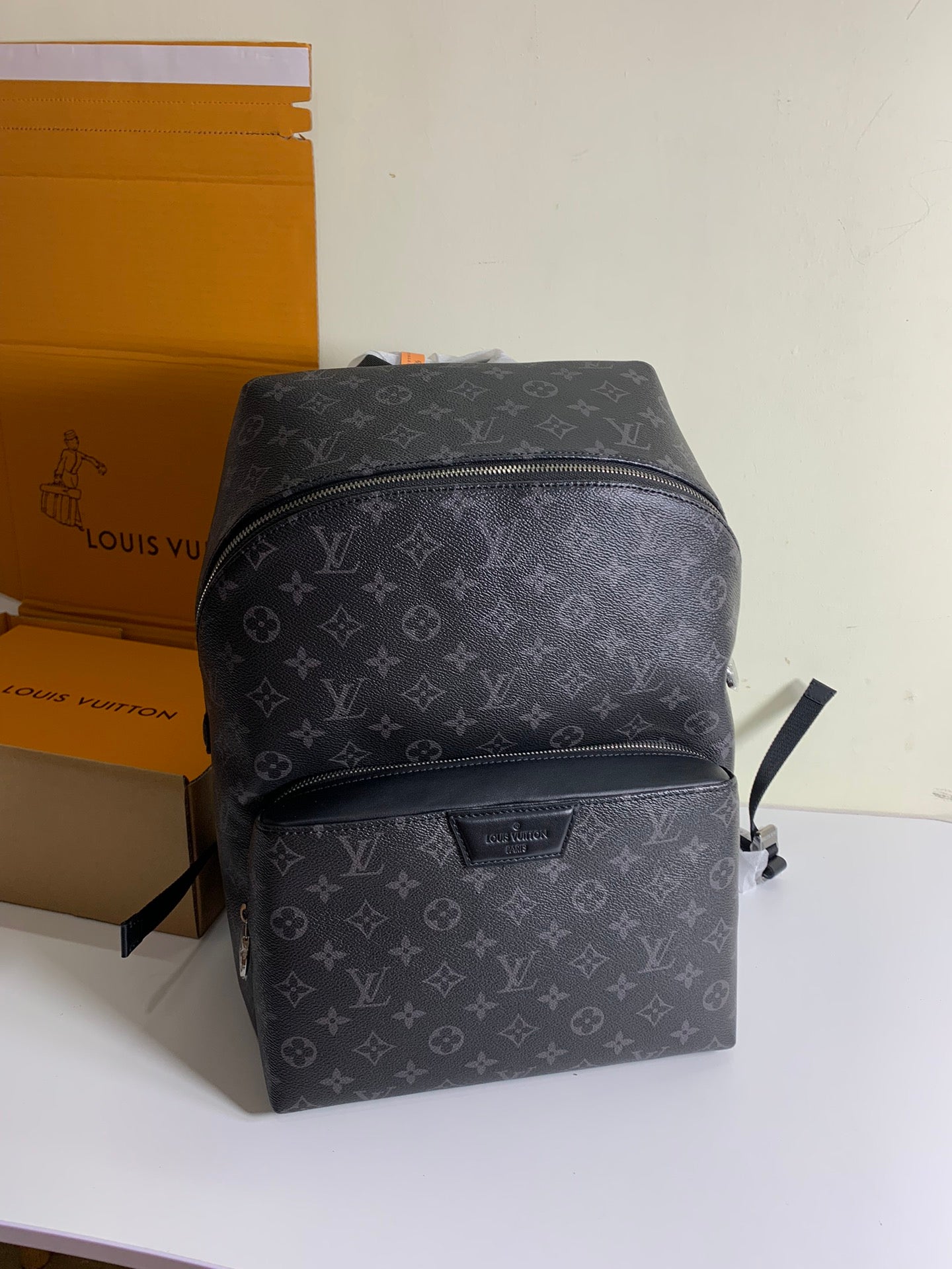 Louis Vuitton monogram backpack with front zipper pocket, dark gray leather trim